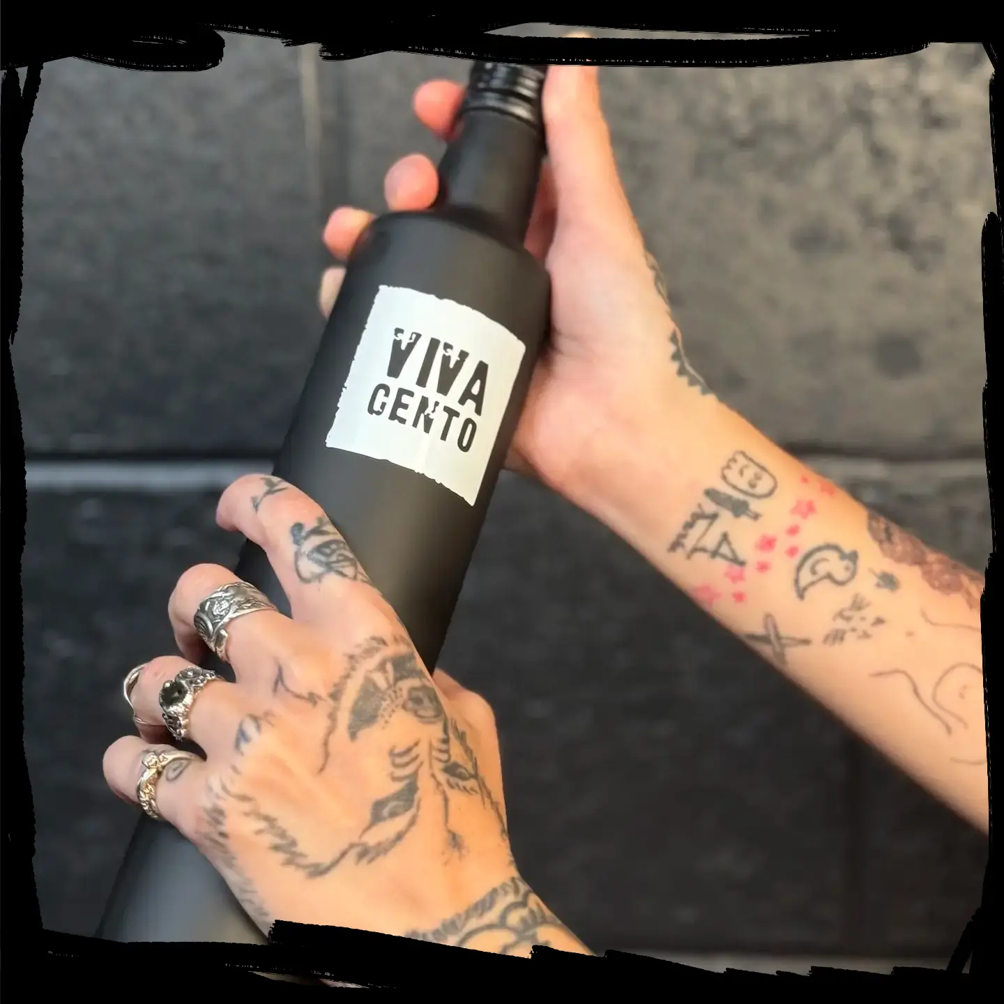 Hand holding a Viva Cento olive oil bottle